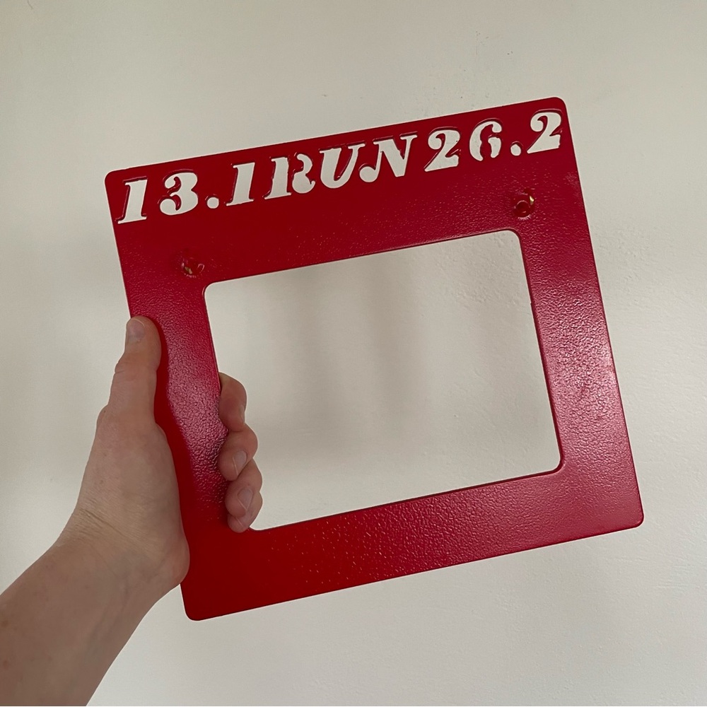 Red metal bib/penant holder for half an full marathons 13.1 and 26.2